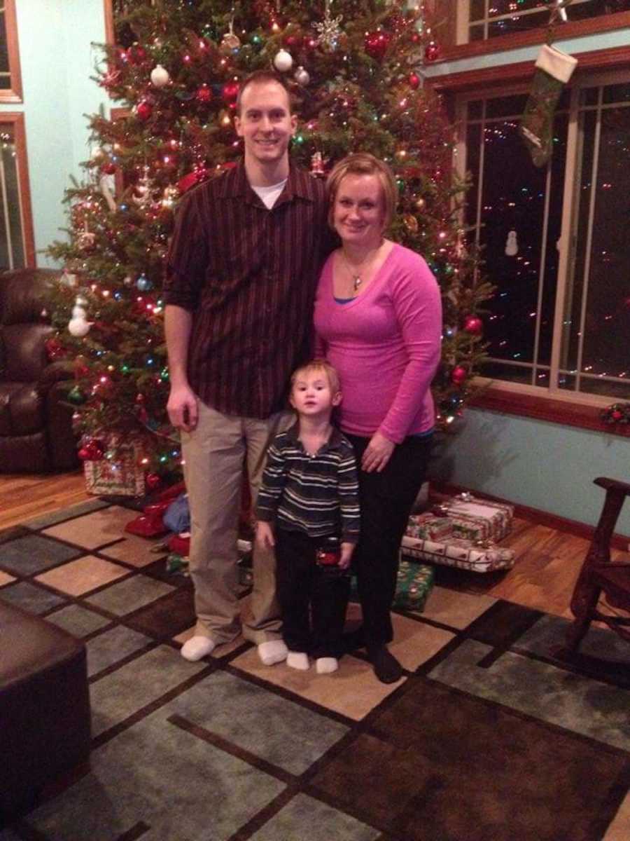 couple and son by Christmas tree