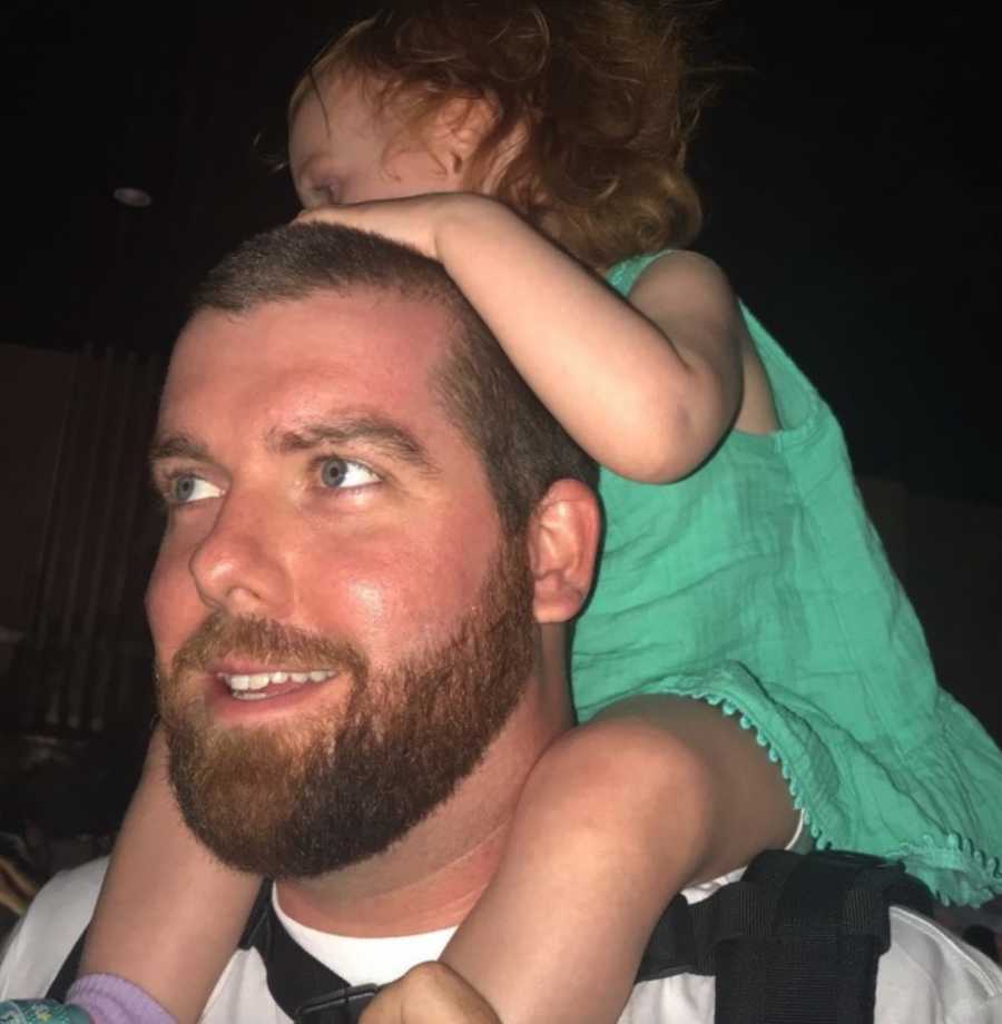 Father carrying daughter on shoulders