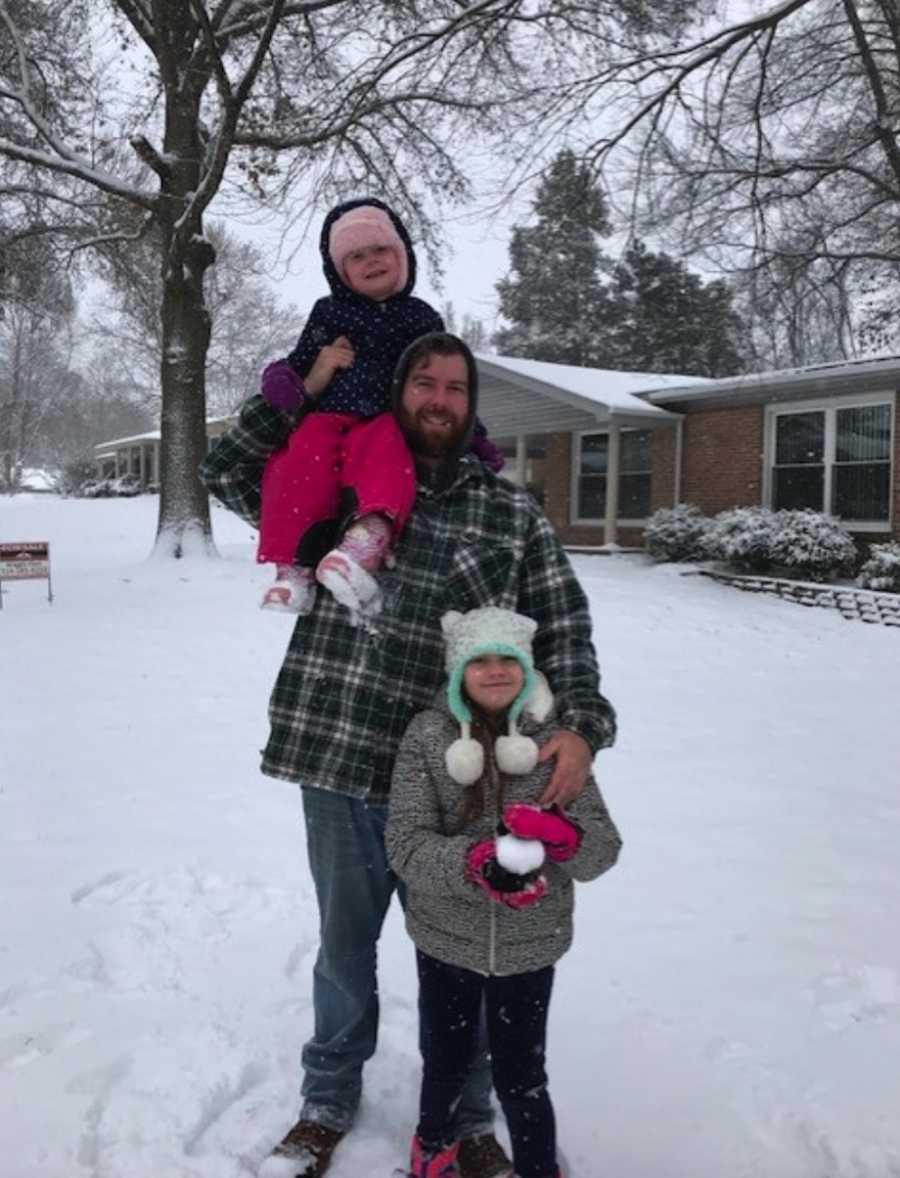 Dad with two daughters in snow