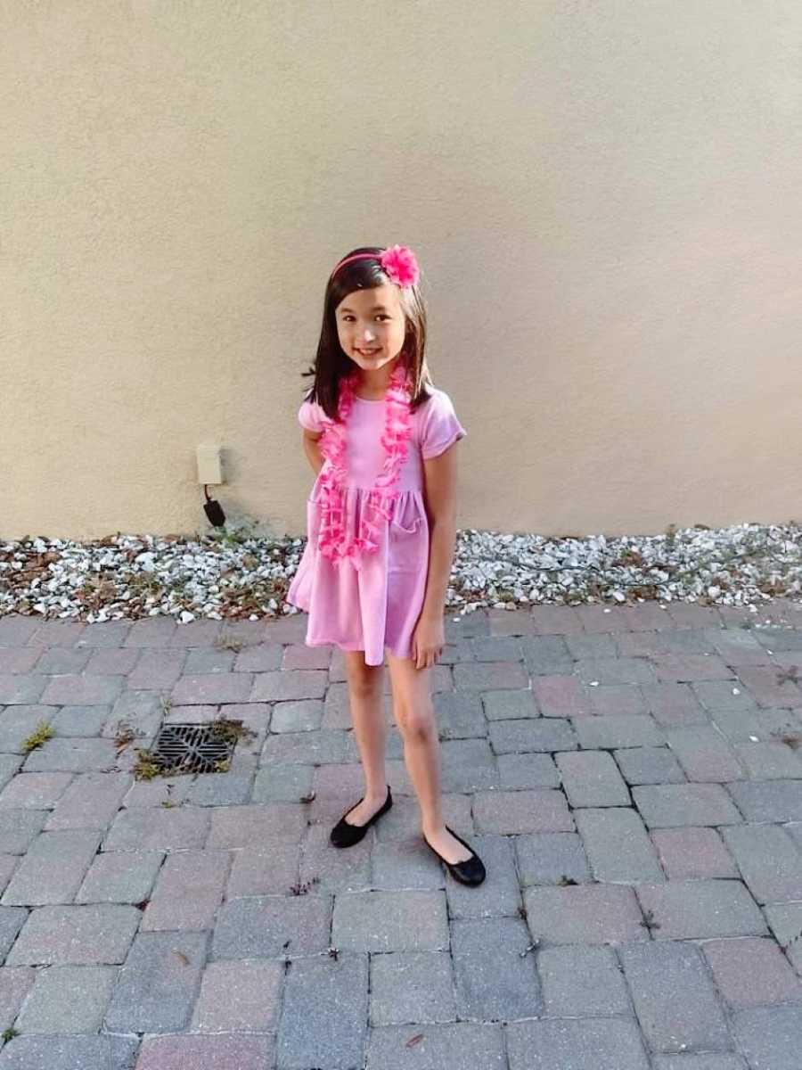 Little girl sassily poses for a photo in all pink floral outfit