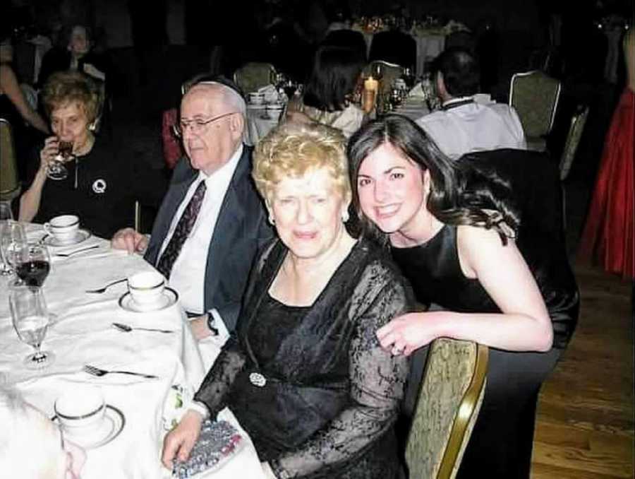 Woman smiles for a photo with her cherished grandmother at a formal event