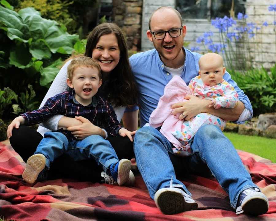 family photo- mom, dad, son, daughter smiling