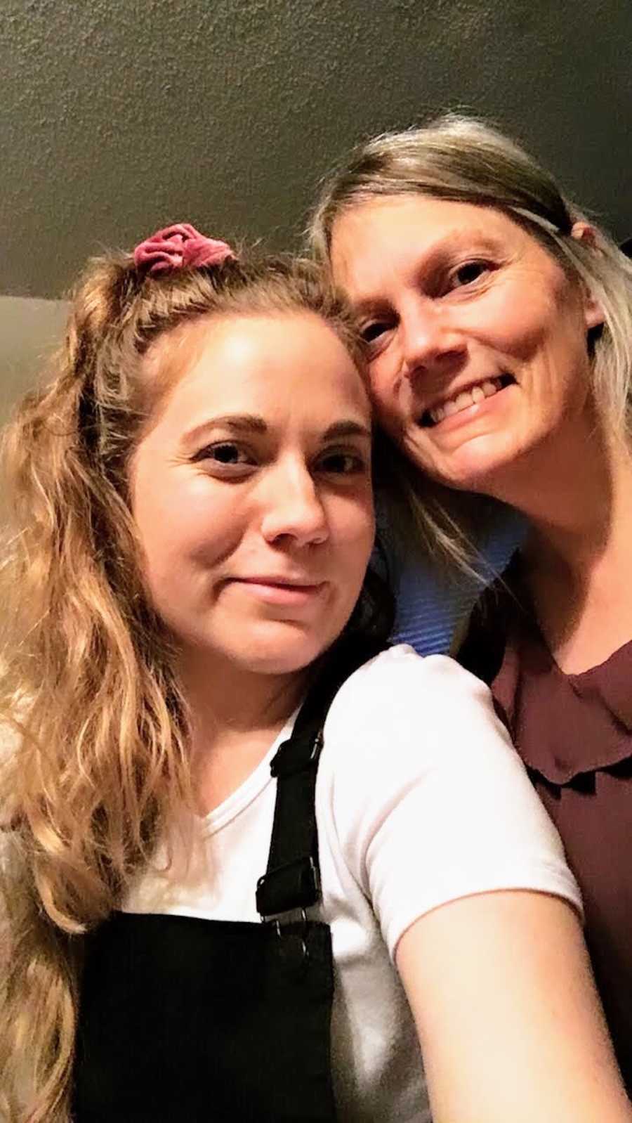 Mother and daughter taking smiling selfie