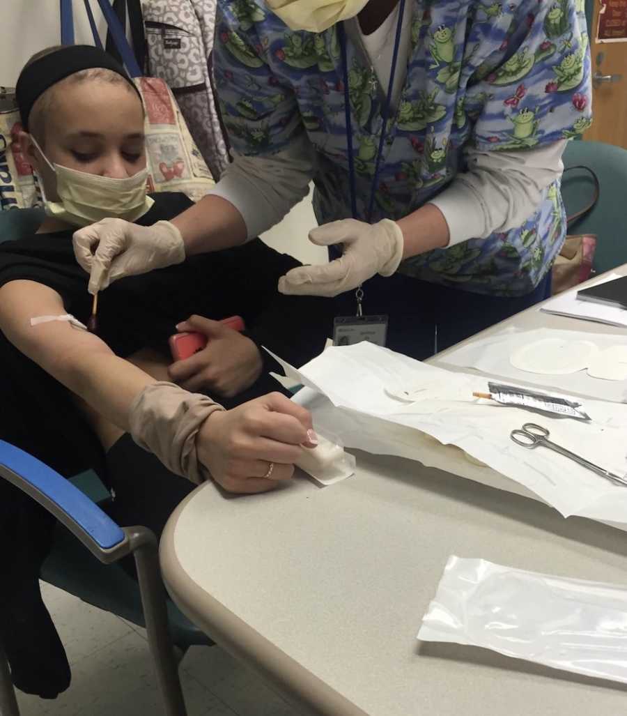 Woman getting IV inserted at hospital 