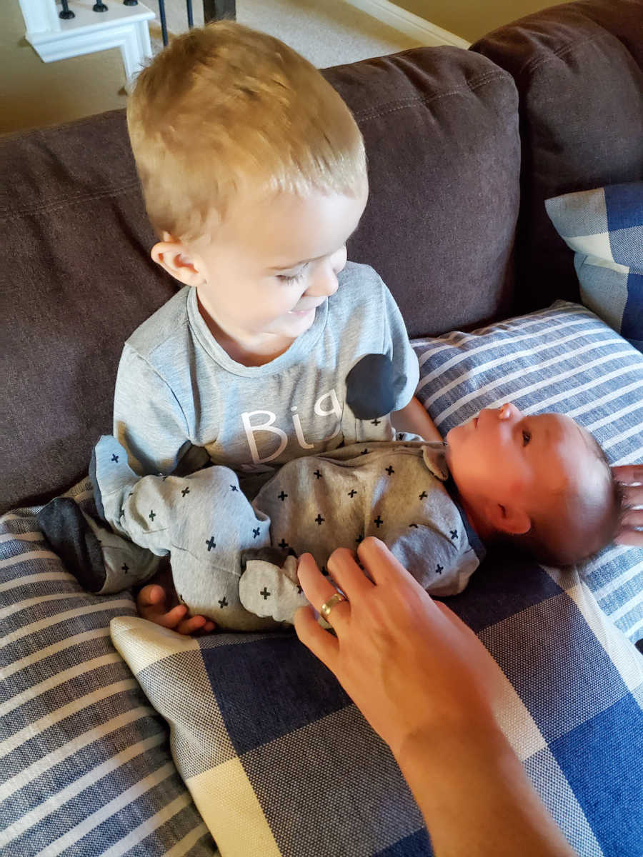 young boy holding younger brother