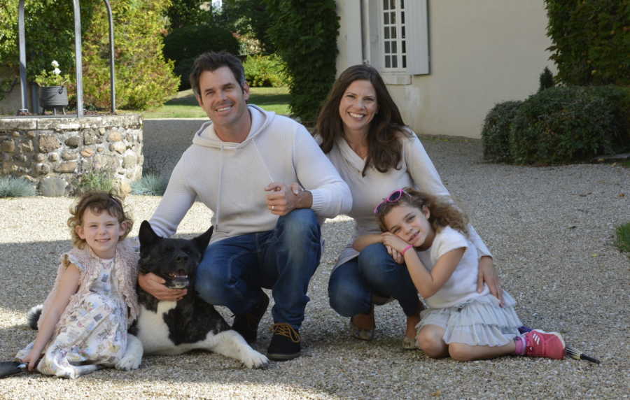 husband, wife, two daughters posing