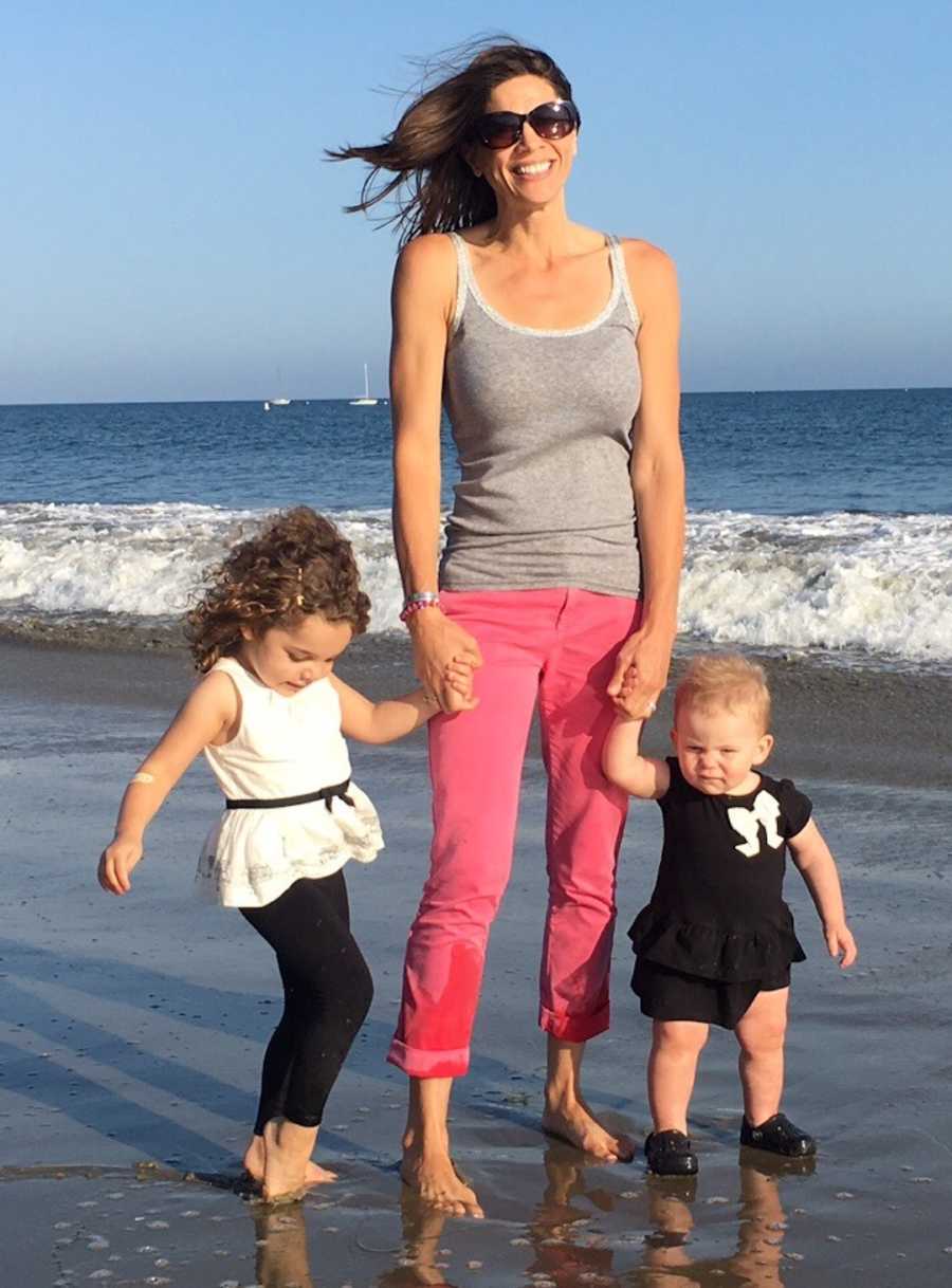 mom and her two daughters on beach