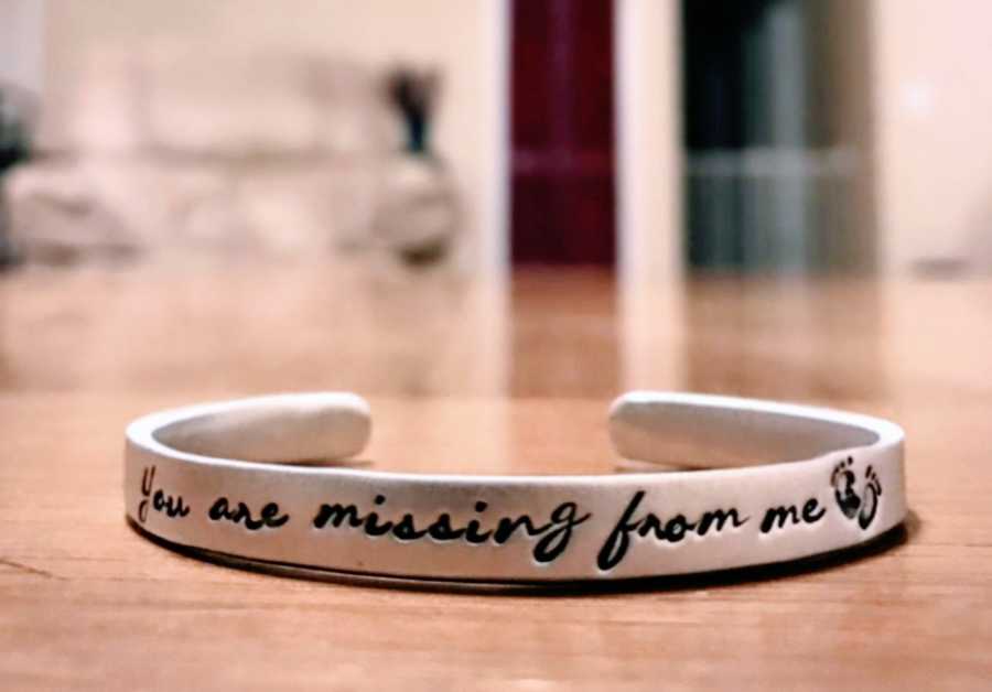 Ring that says "You are missing from me" with footprints brings awareness of infertility