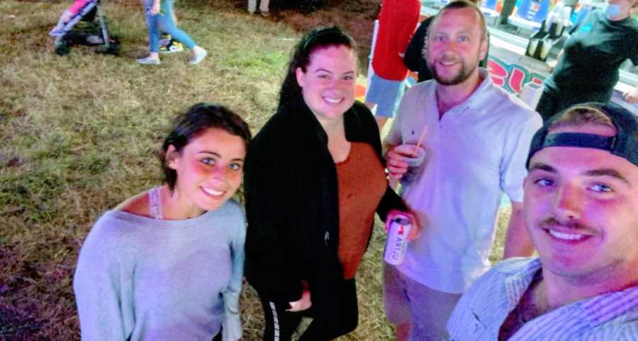 Group shot of two married couples hanging out and drinking beers