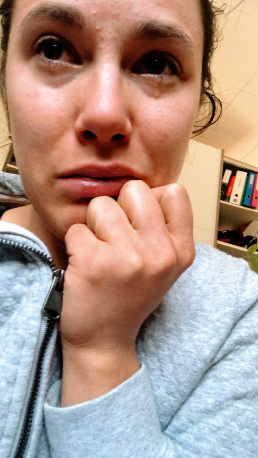 Woman with Epstein-Barr Virus cries while trying to concentrate on homework