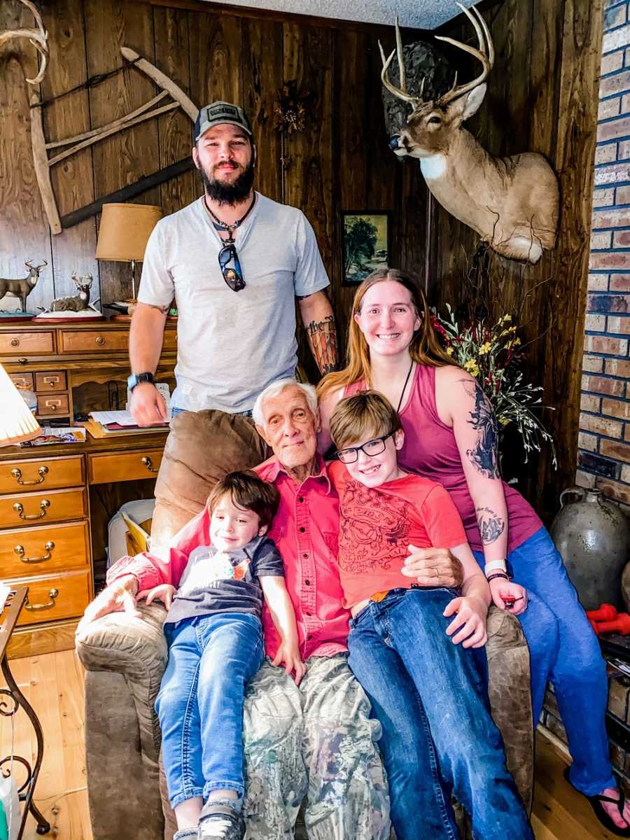 A disabled woman and her family pose with her grandfather