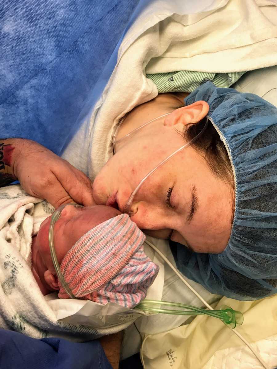 A disabled mother kisses her newborn shortly after his birth