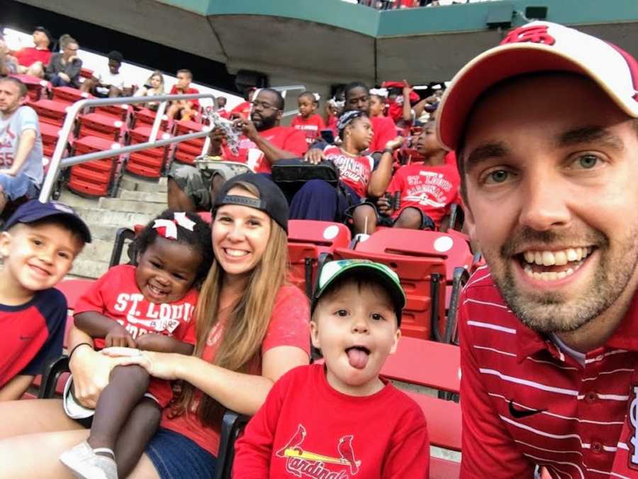 Family sitting in stands at Cardinal's baseball game