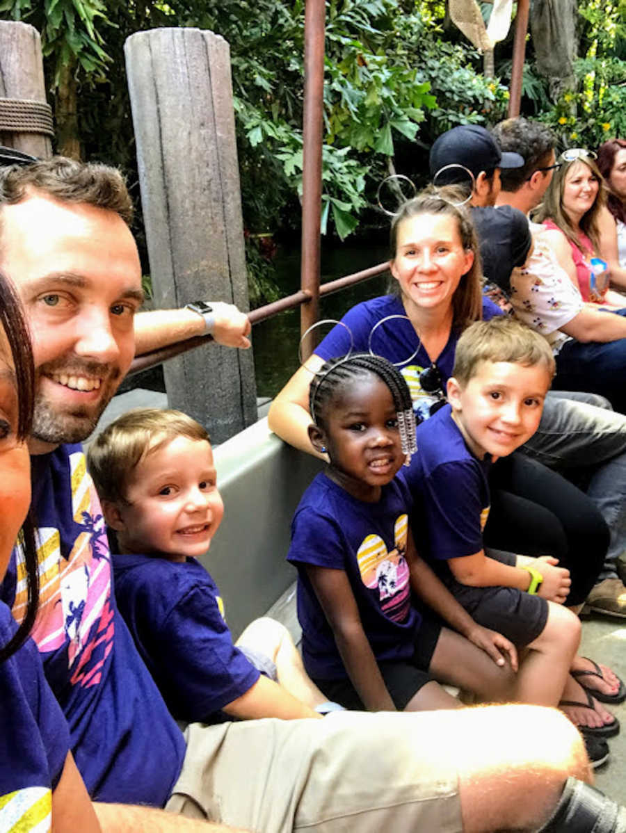 Family of five sitting in line for a ride at Disney