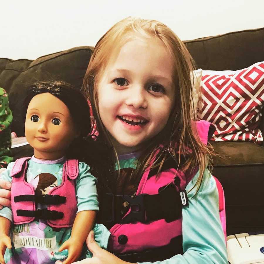 Baby girl wearing cystic fibrosis vest with matching doll