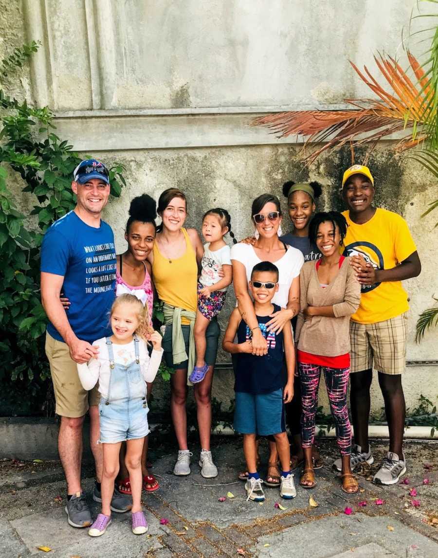 Family of 10 standing outside smiling