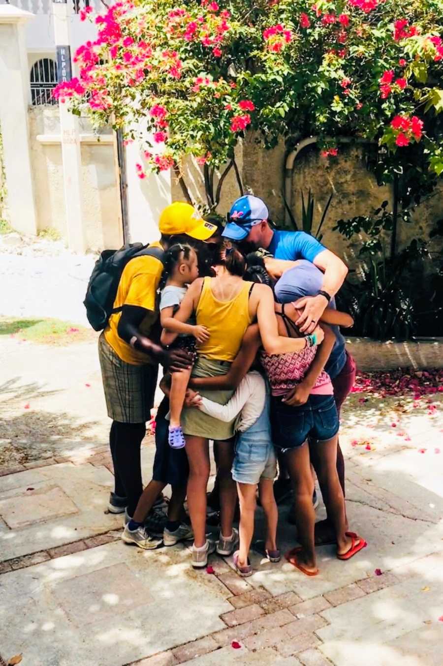 Family hugging each other outside