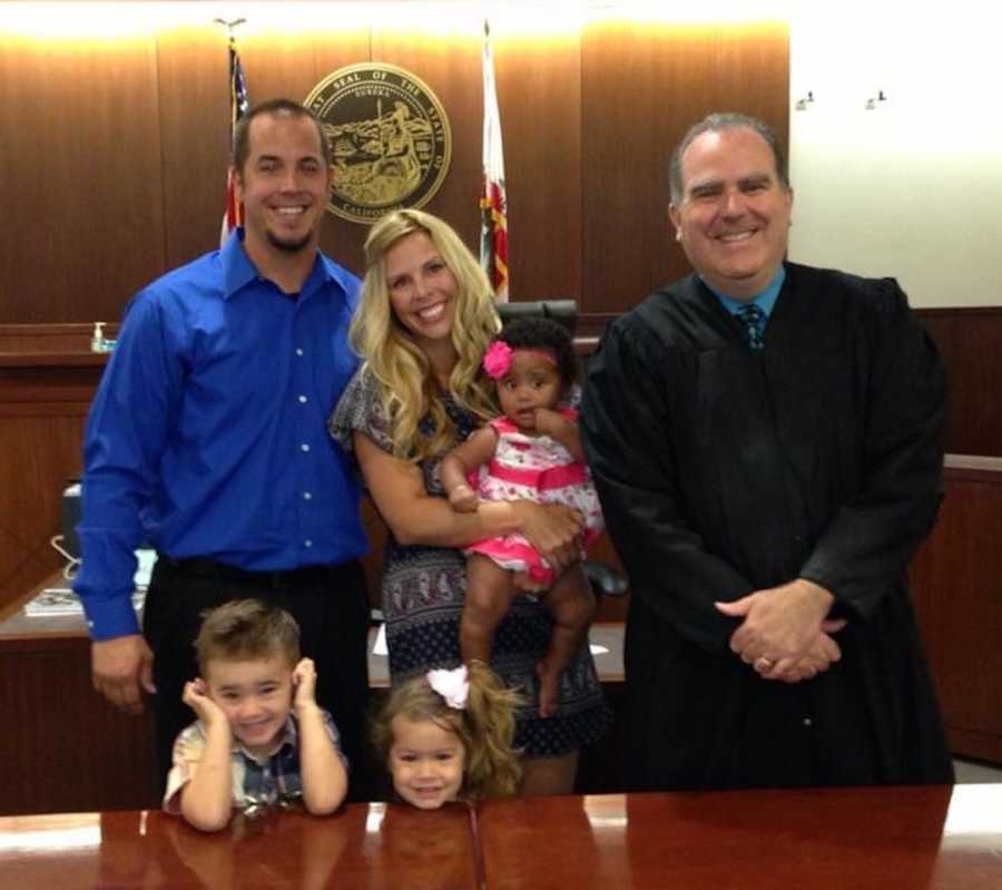 family in courthouse after adoption