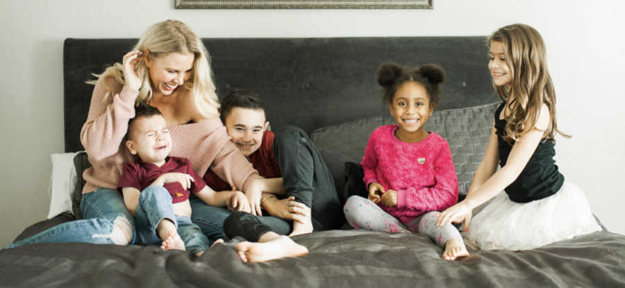 smiling family on bed