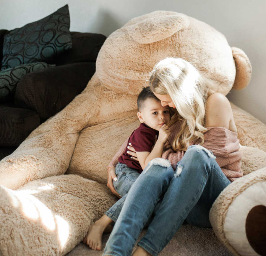 mom holding baby on stuffed animal