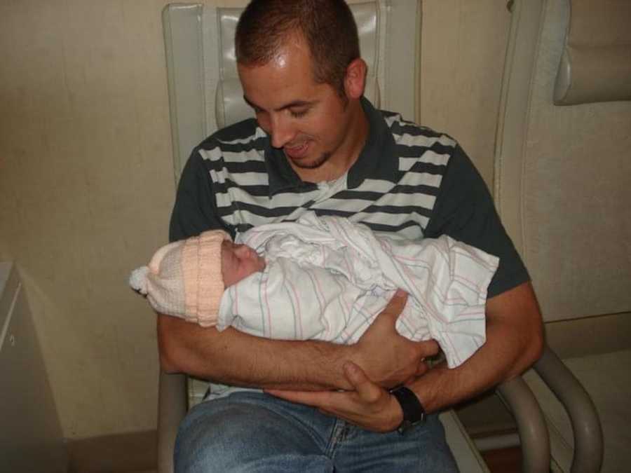 father holding newborn