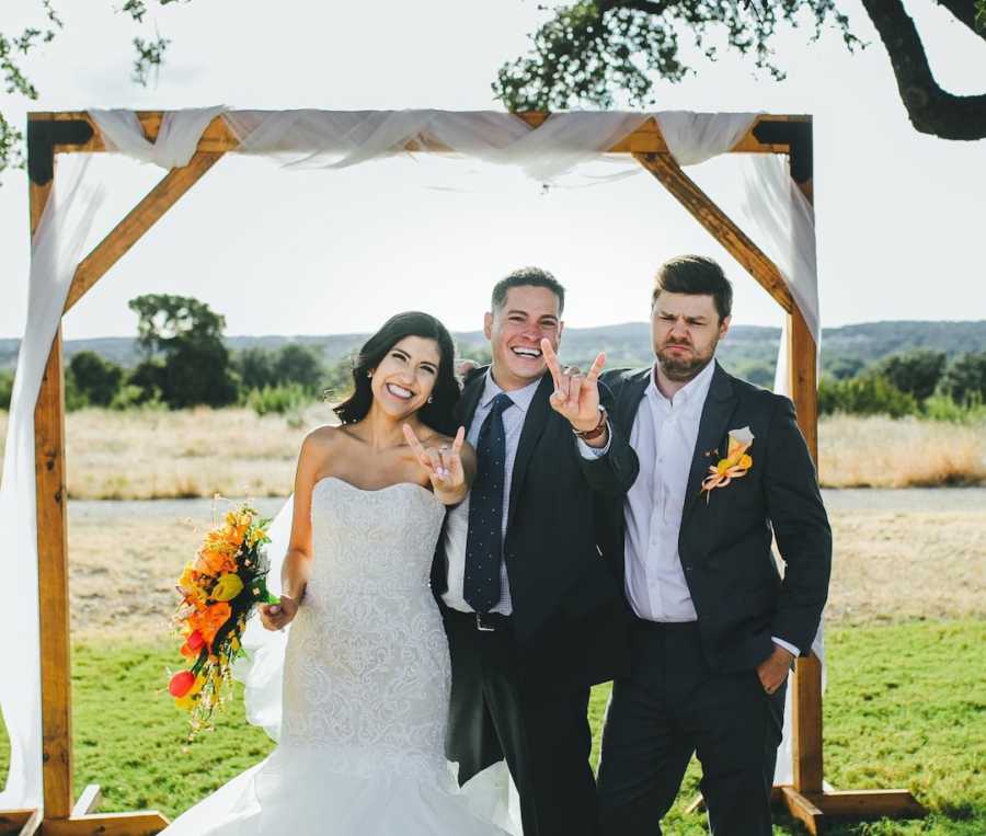 Bride in wedding gown with two men in tuxedos