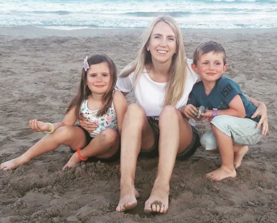 woman on beach with kids