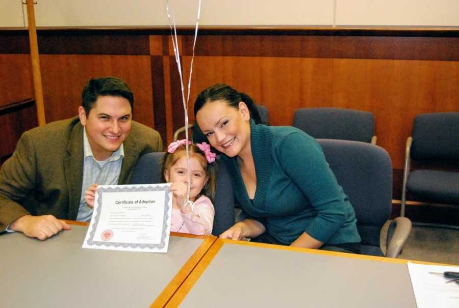 Adoptive parents and daughter on adoption day