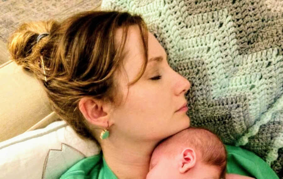 Mother holding newborn son on chest both sleeping