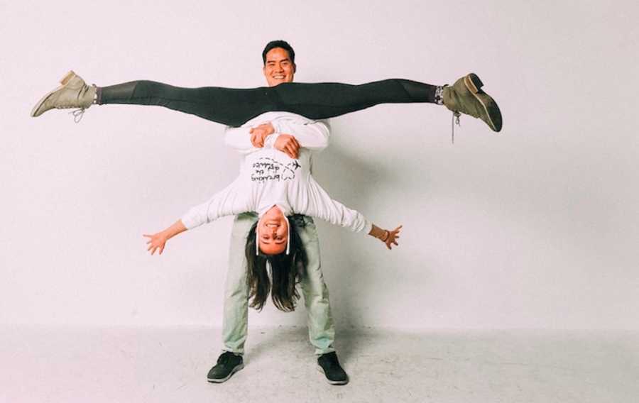 Man holding woman upside down and smiling