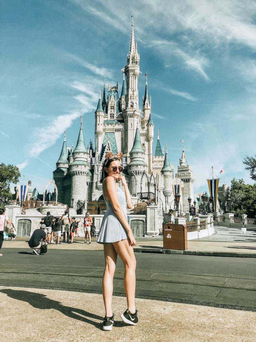 Young woman wearing sunglasses at Walt Disney World