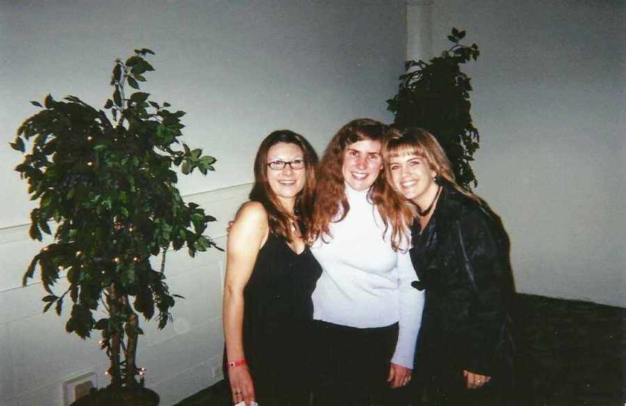 A widow stands with two of her friends