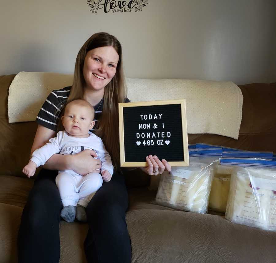 woman with baby holding sign 'donated breastmilk'