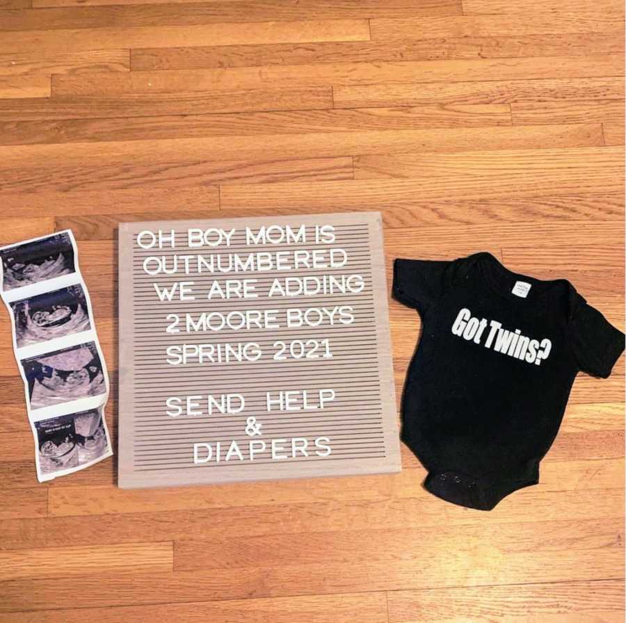 Ultrasound images with black onesie and gray letterboard birth announcement