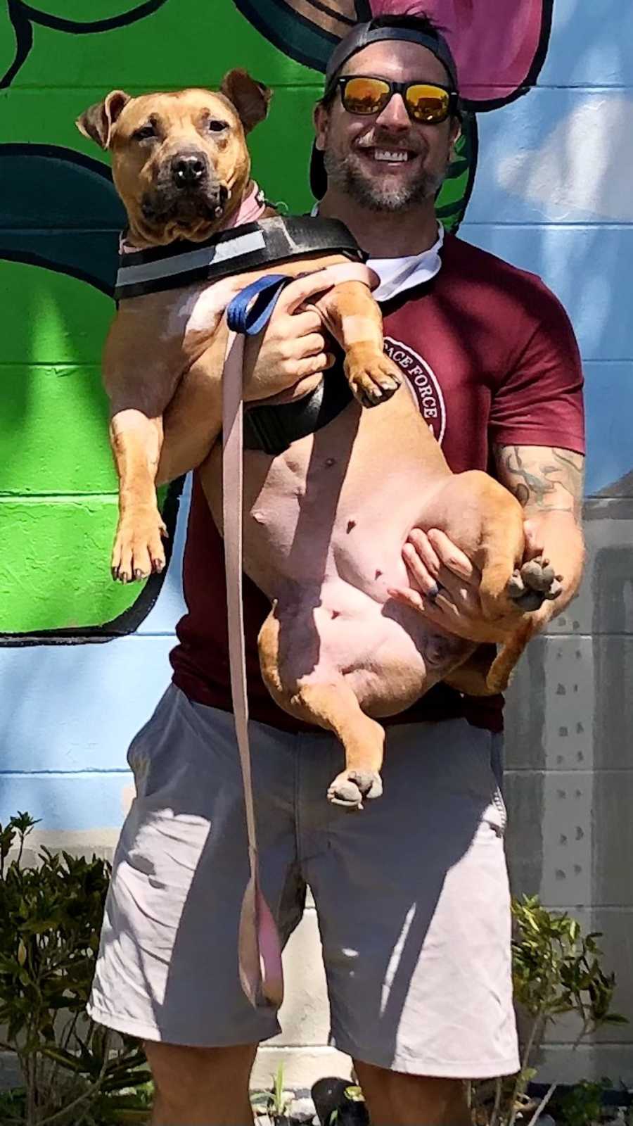 man holding a dog