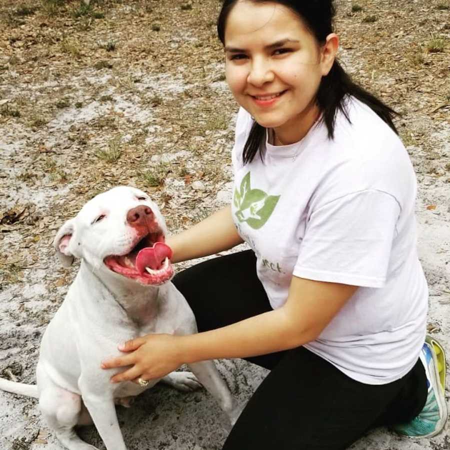 smiling girl posing with a dog