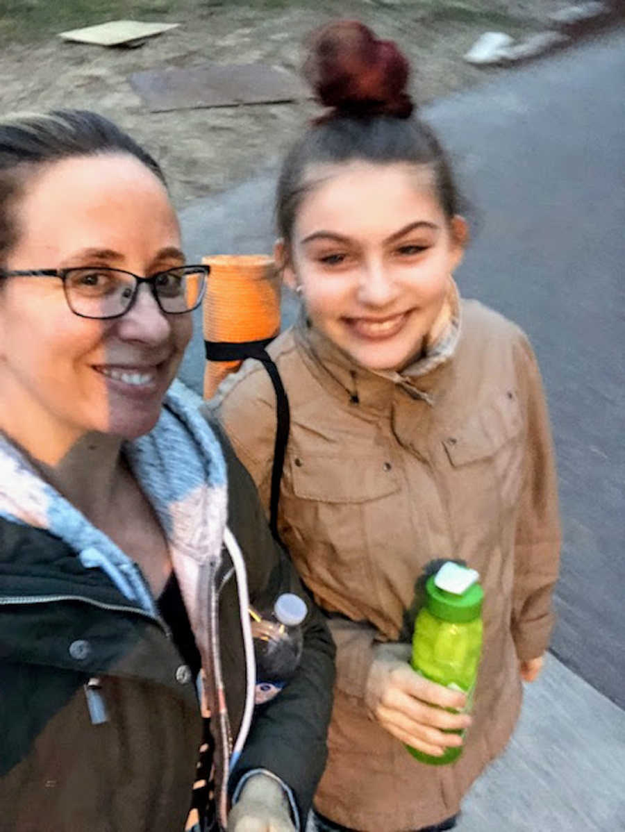 Two women standing outside taking smiling selfie