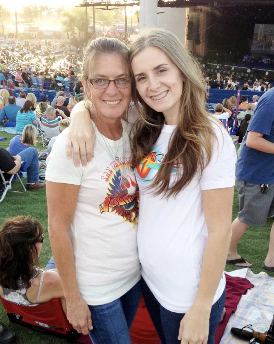 Mother and daughter smiling at a concert