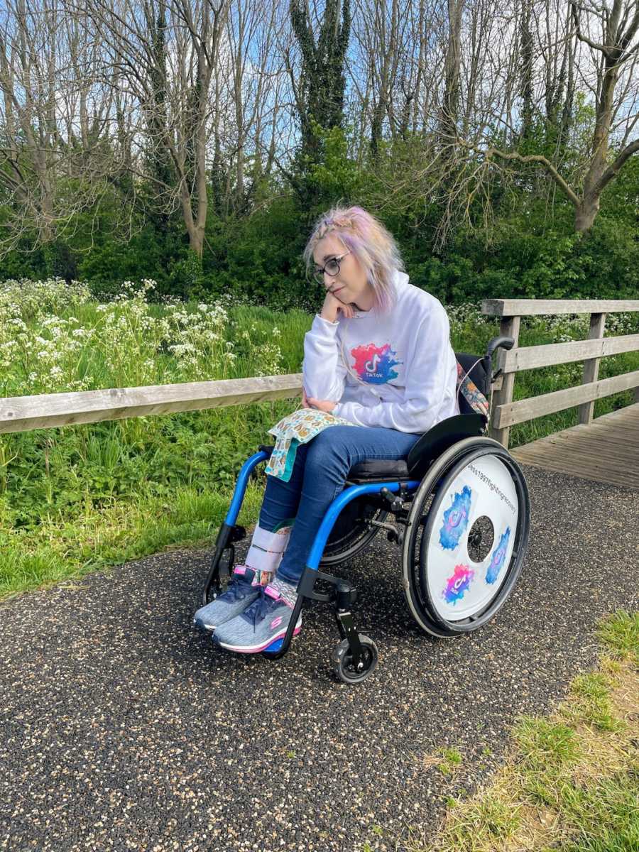 Woman in wheelchair on nature path