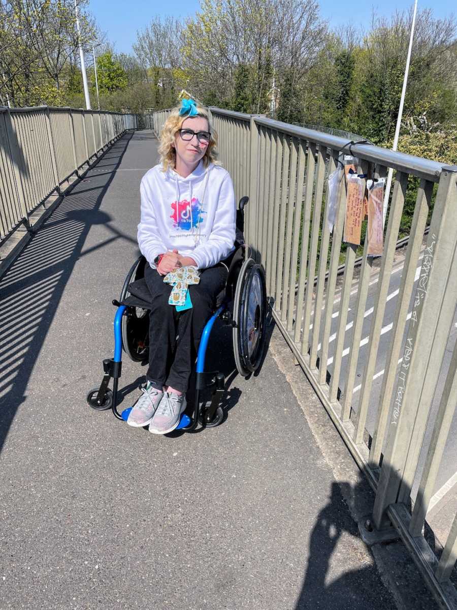 Woman in wheelchair on bridge