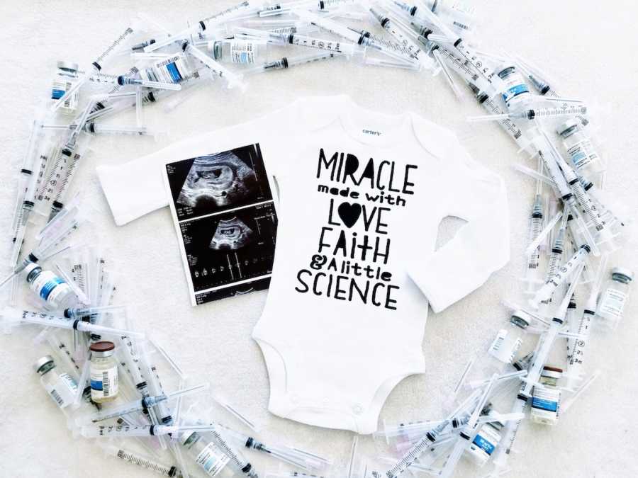 Onesie and ultrasound images surrounded by fertility injections