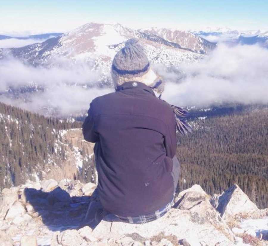 teenage boy staring at mountain