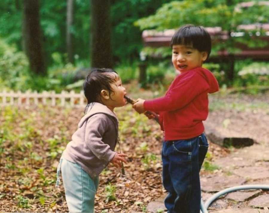 two siblings playing outside