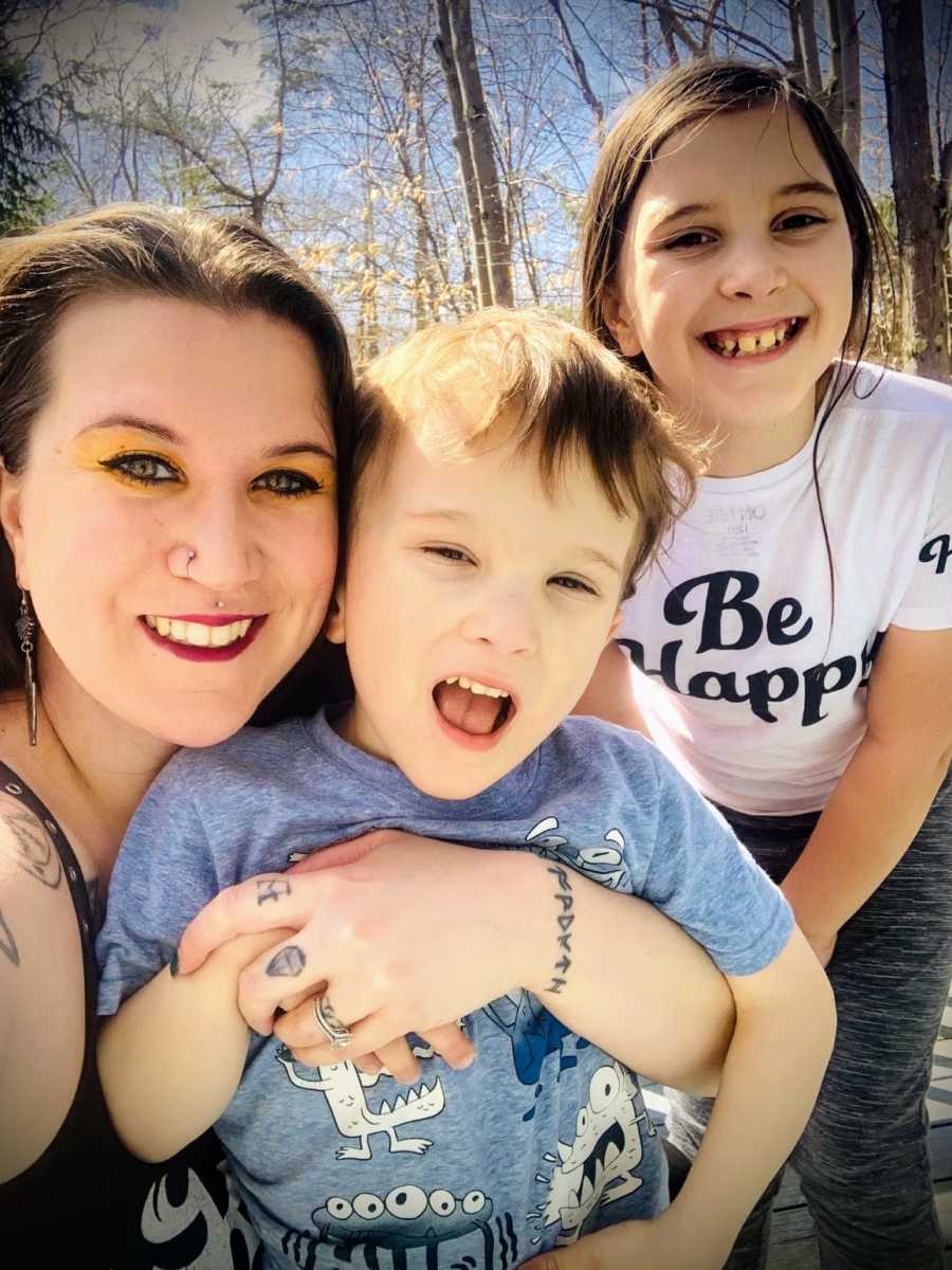 Mother with autistic son and daughter, smiling