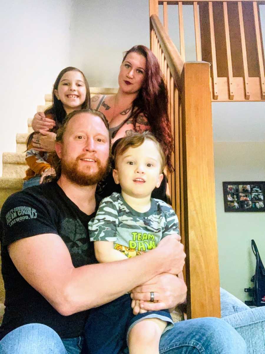 Family with autistic son seated on stairs