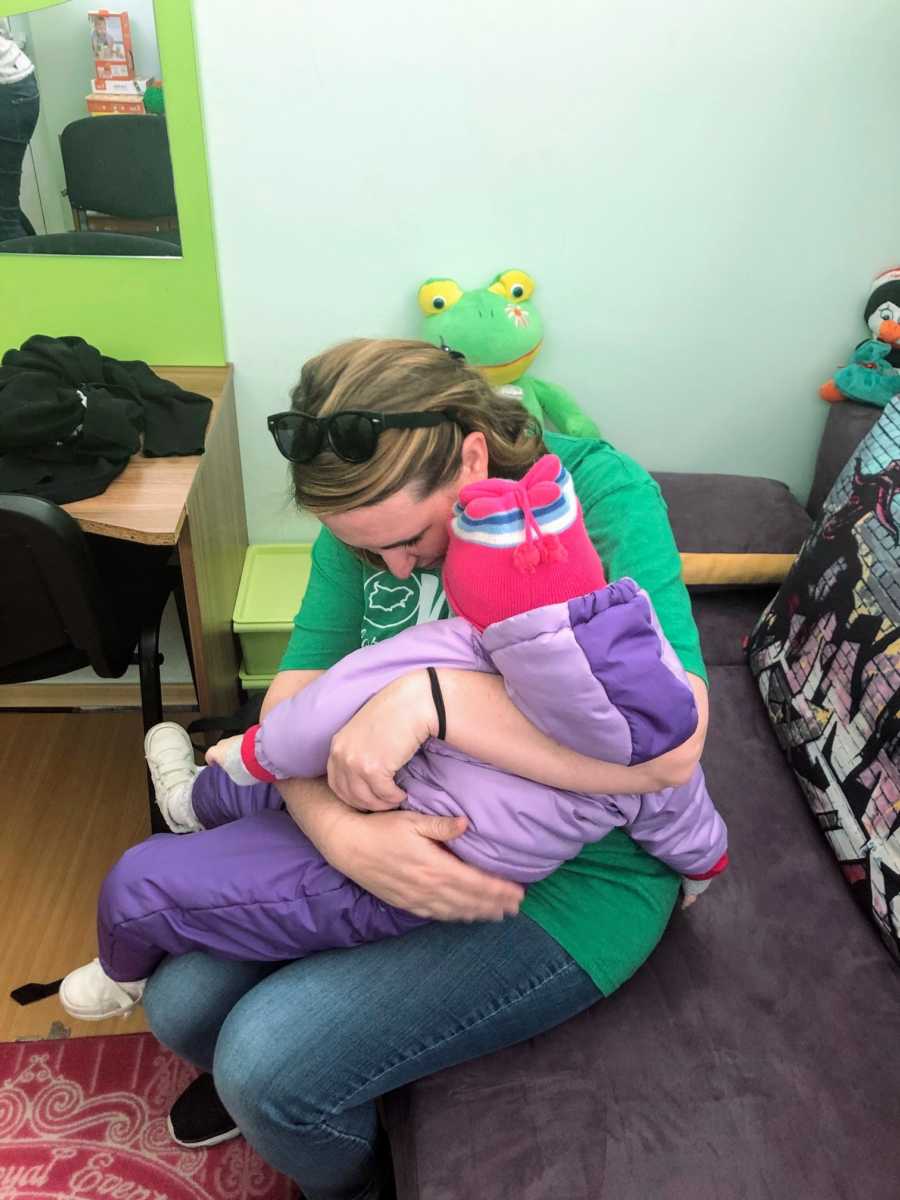 An adoptive mom holds her special needs daughter for the first time