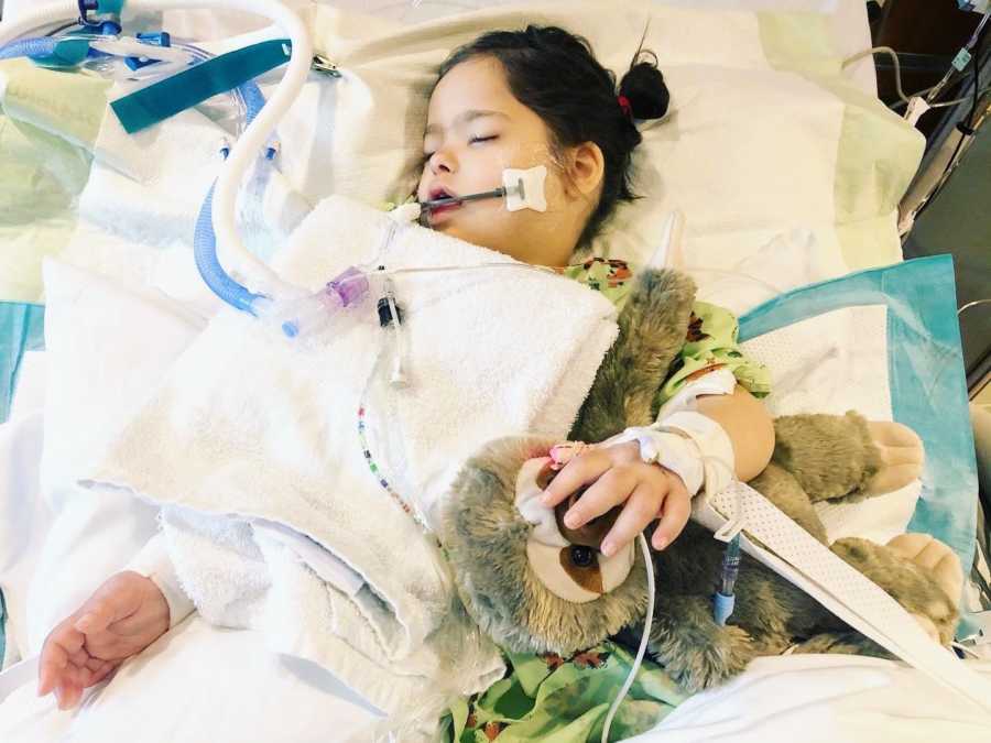 A special needs girl hooked up to machines in a hospital