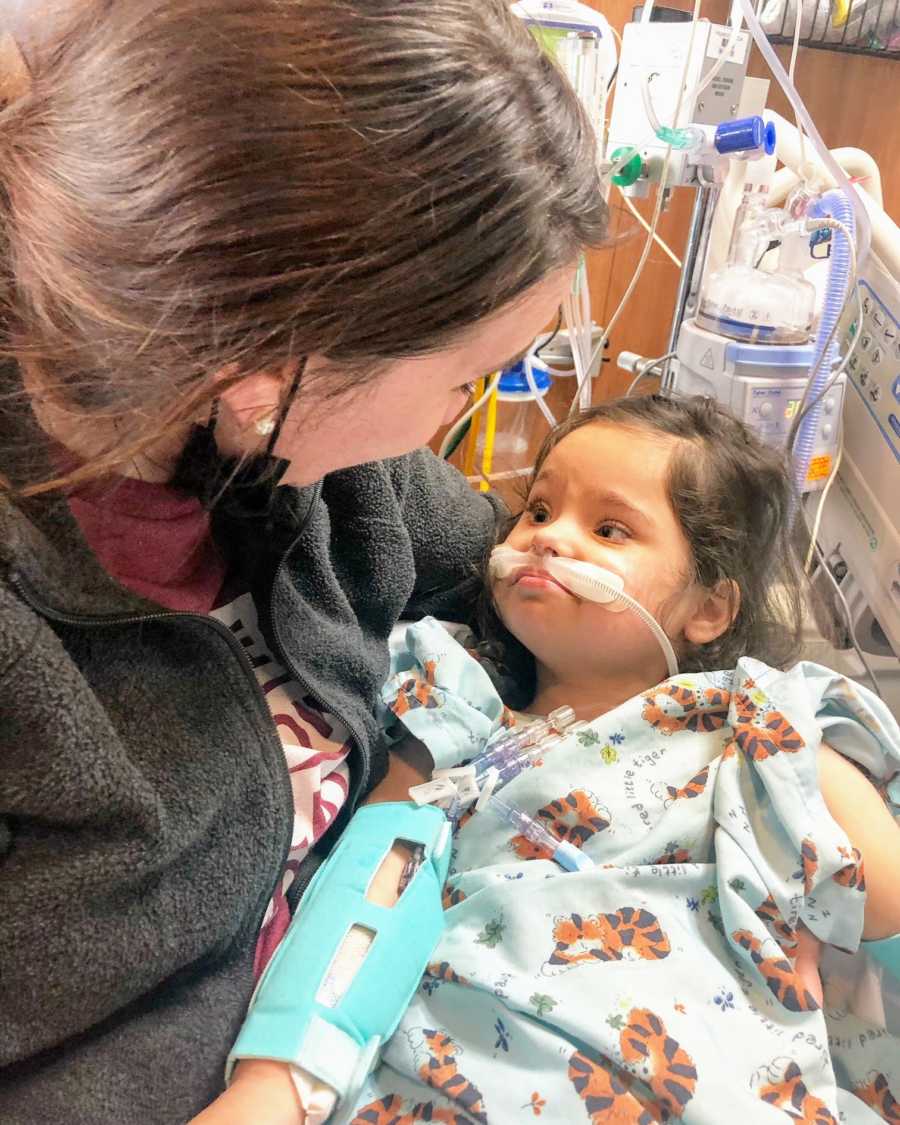 An adoptive mom holding her daughter in the hospital