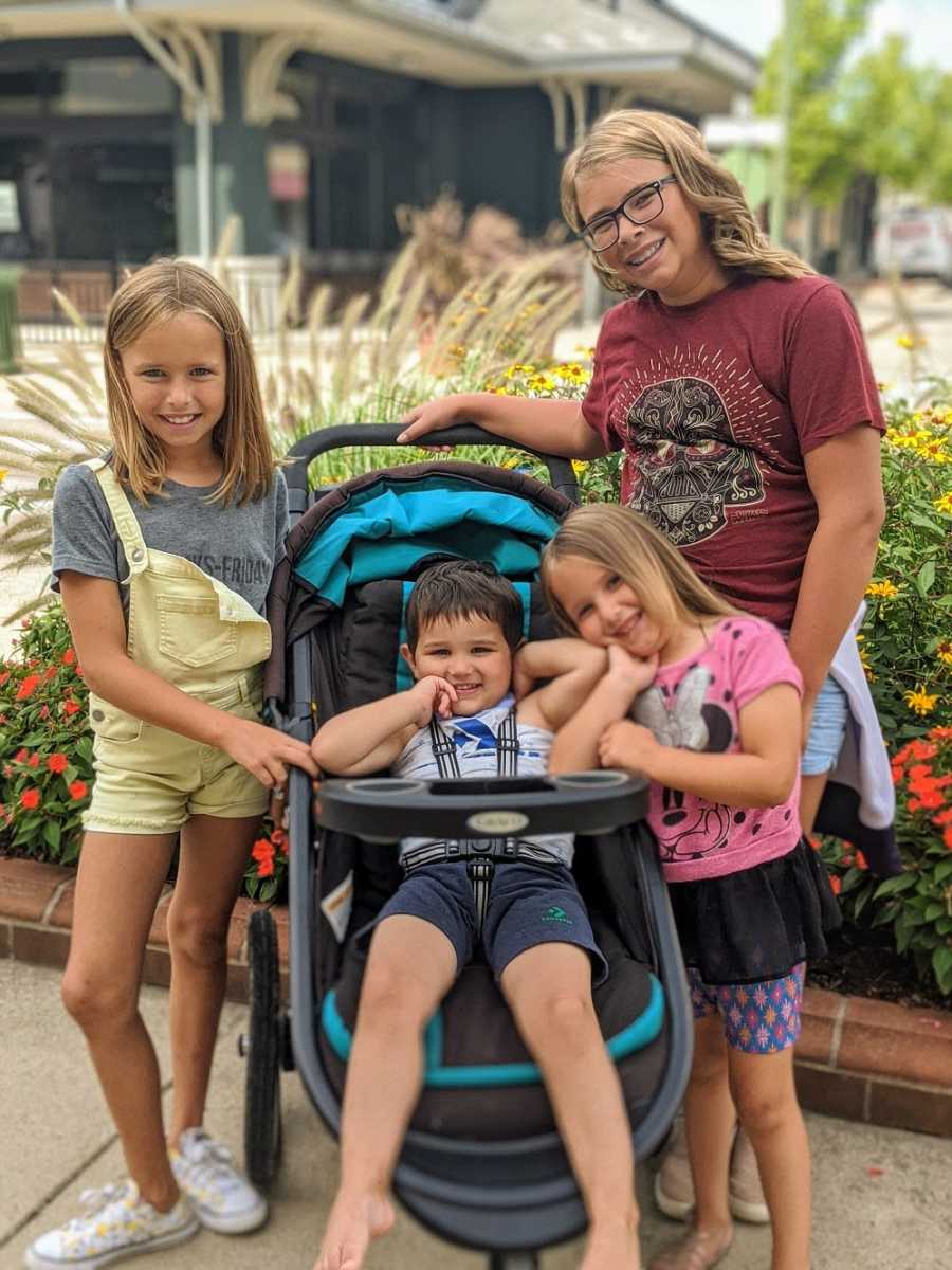 Foster family posing with foster son, smiling