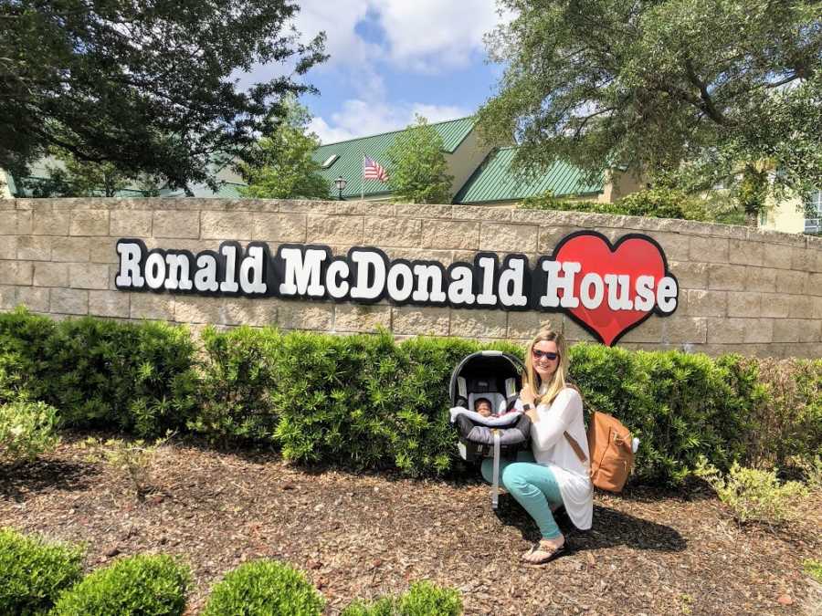 An adoptive mother with her baby outside the Ronald McDonald House